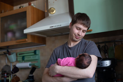 Portrait of young man sitting at home
