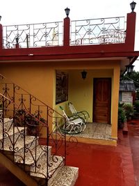 Bicycle by house against sky