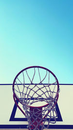 Low angle view of basketball hoop against clear blue sky