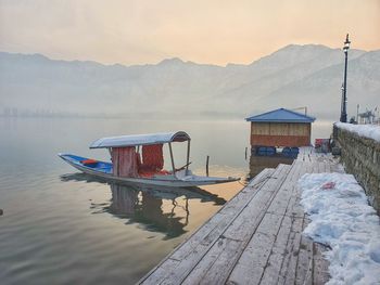 Scenic view of lake by snowcapped mountains against sky