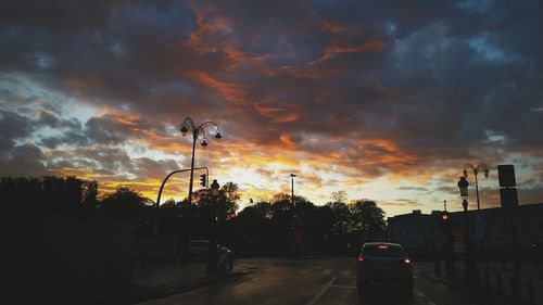 Road against cloudy sky at sunset