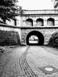 Arch bridge on street against building