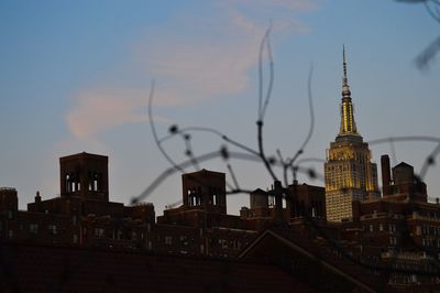 Buildings in city against sky during sunset