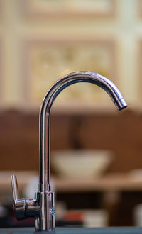 Close-up of faucet in bathroom at home