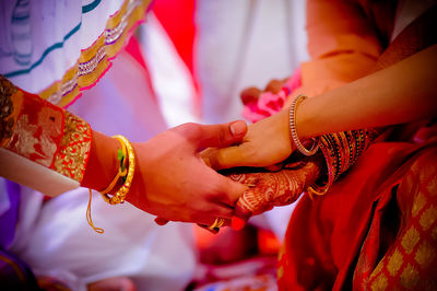 Close-up of friends with stacked hands during ceremony