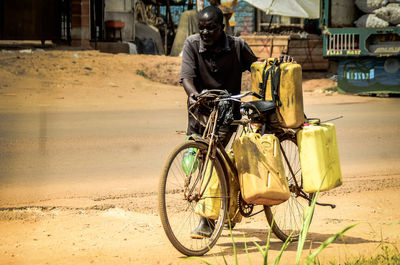 Rear view of man riding bicycle on street