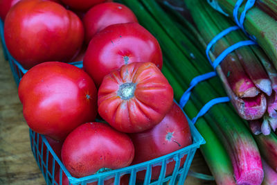 Full frame shot of container filled with ripe red tomatoes for sale at farmers market 