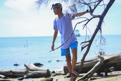 Man standing on beach against sky