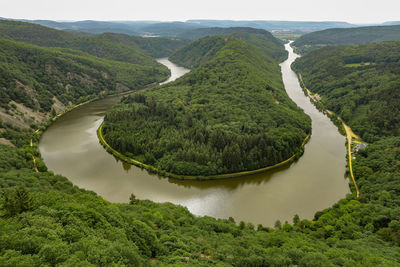 High angle view of river amidst green landscape