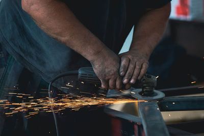 Midsection of man welding metal