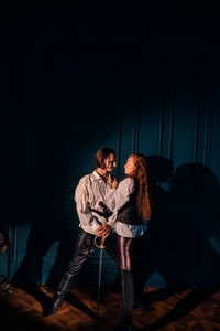 Young couple sitting in the dark