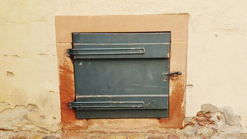 Close-up of mailbox on brick wall