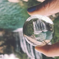 Close-up of hand holding crystal ball