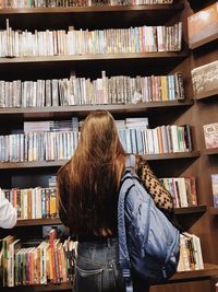 Rear view of woman reading book