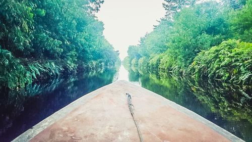 View of swimming pool by lake against sky