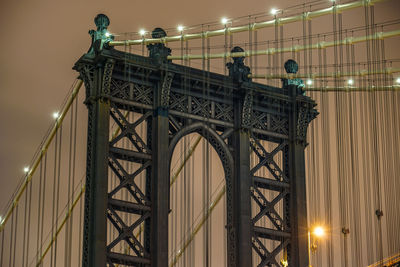 Low angle view of bridge against sky at night