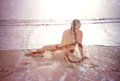 Woman standing by sea