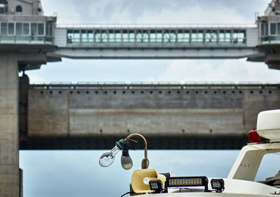 Close-up of bridge against sky in city