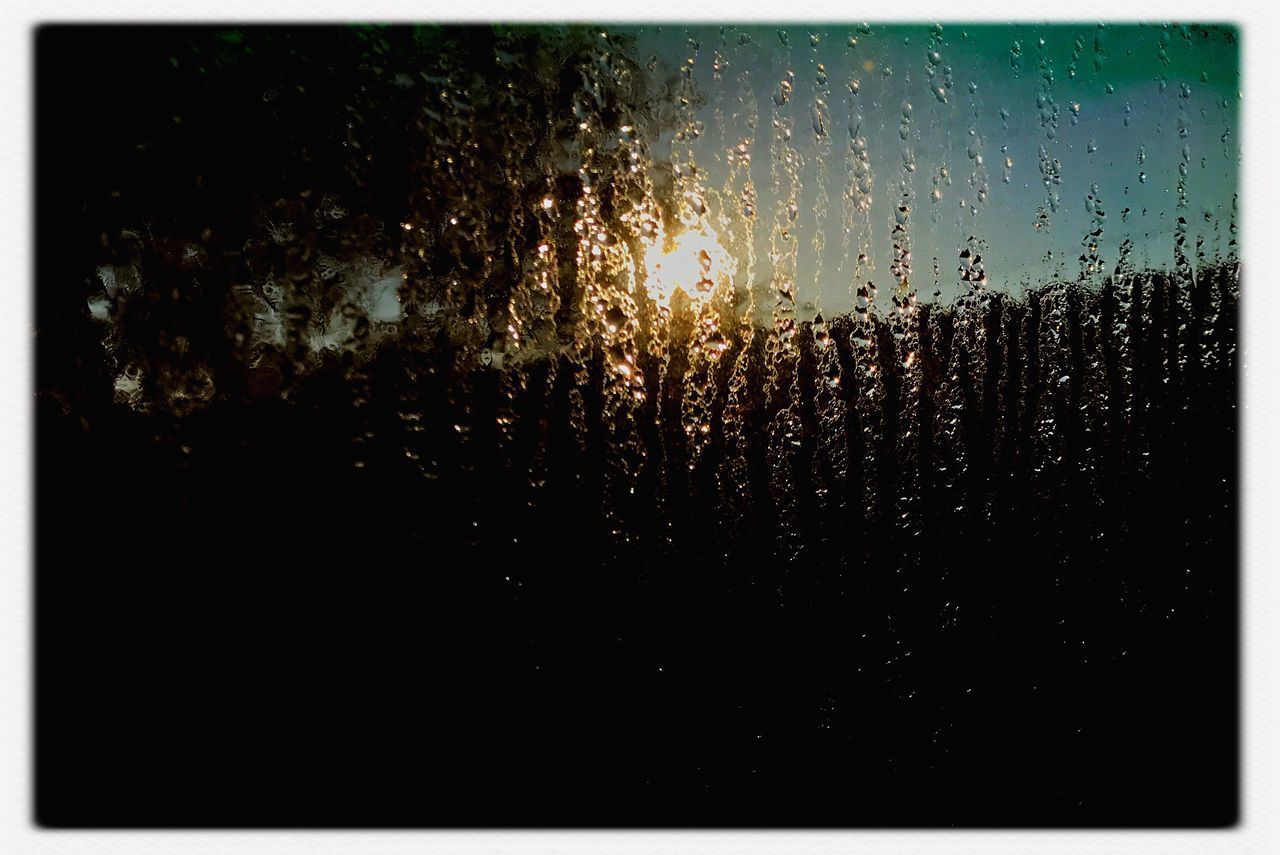 CLOSE-UP OF RAINDROPS ON WINDOW