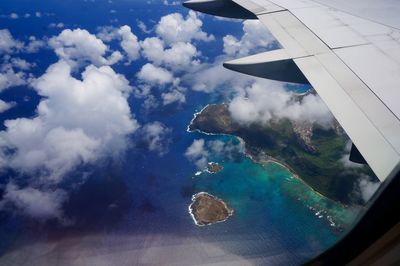 Aerial view of sea and airplane wing