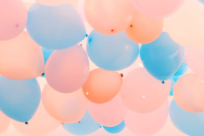 Low angle view of balloons against sky