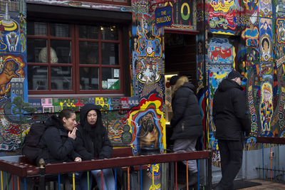 People standing by building in city