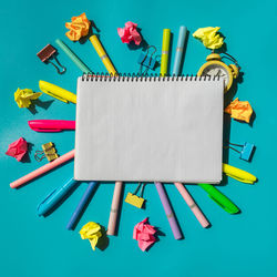 Directly above shot of beauty products against blue background