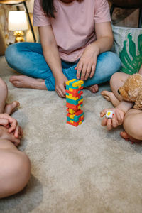 High angle view of boy playing with stuffed toy