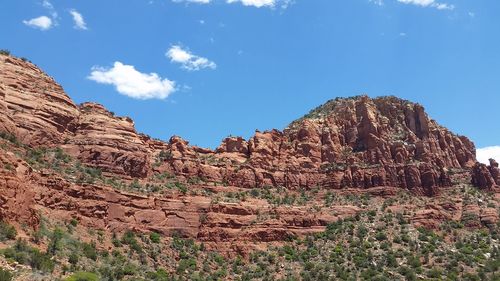 Low angle view of rocky mountain against sky