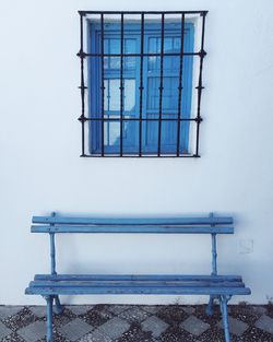 Wooden bench by wall at manuel de falla