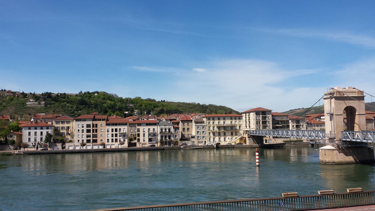 architecture, building exterior, built structure, water, sky, waterfront, house, residential structure, residential building, river, blue, tree, mountain, day, lake, town, cloud, nautical vessel, outdoors, reflection