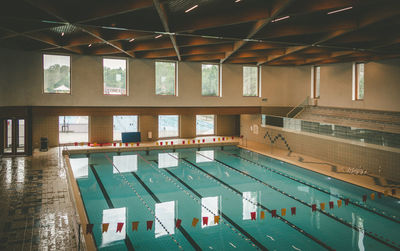 Empty swimming pool against building