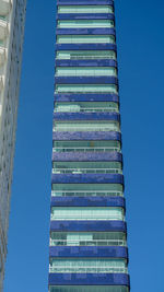 Low angle view of modern building against clear blue sky