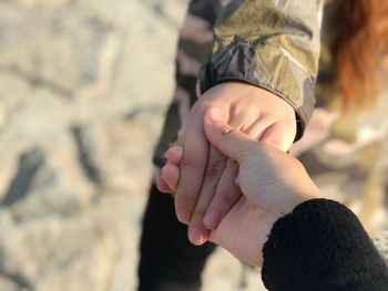 Close-up of man holding hand of woman 