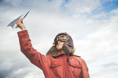 Low angle view of man standing against sky