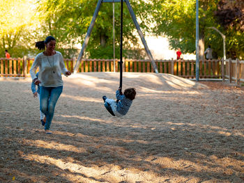 Son chasing mother at playground