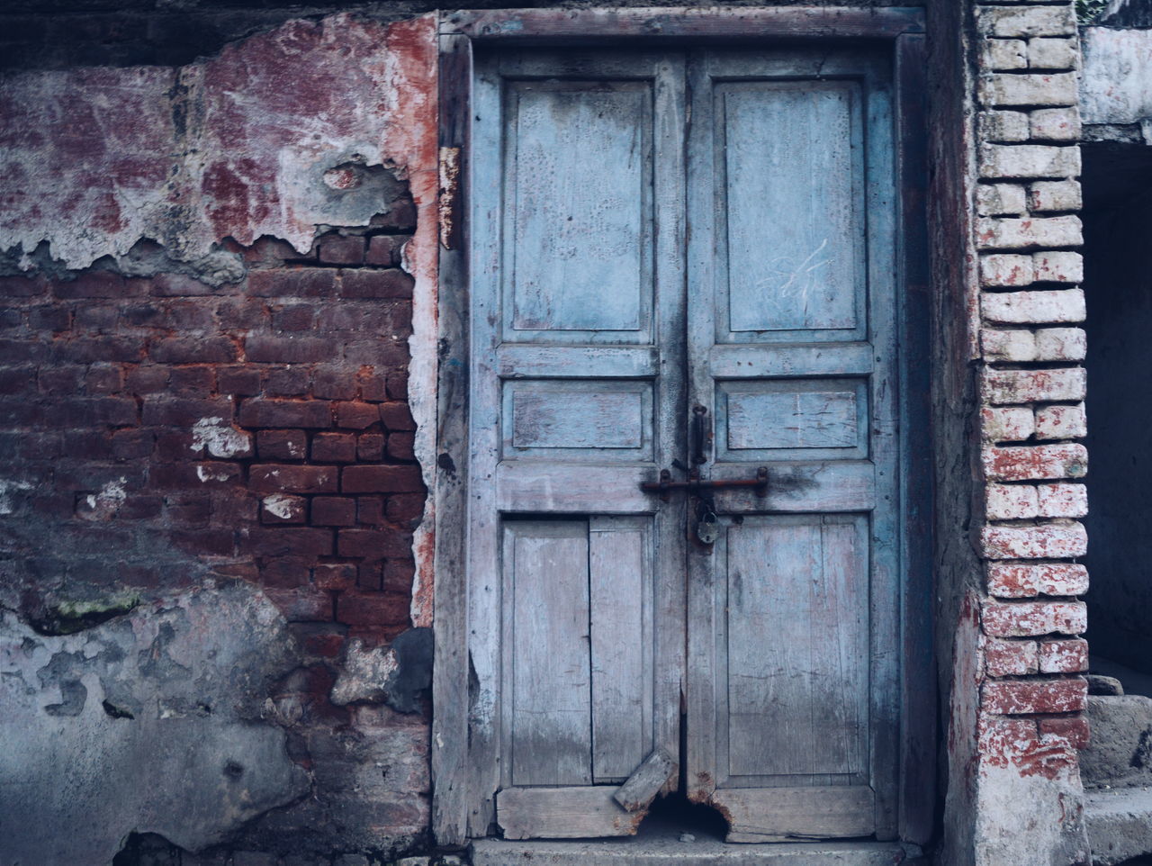 built structure, architecture, building exterior, door, old, closed, weathered, house, window, wall - building feature, wood - material, protection, safety, abandoned, damaged, security, brick wall, entrance, outdoors, deterioration