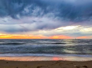 Scenic view of beach against sky during sunset