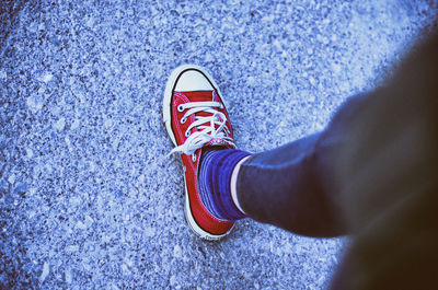 Low section of person standing on tiled floor