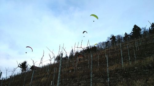 Low angle view of flying kite against sky