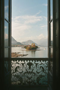 Scenic view of sea against sky seen through window