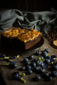 Close-up of cake in plate with blueberries on table