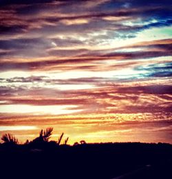 Silhouette landscape against sky during sunset