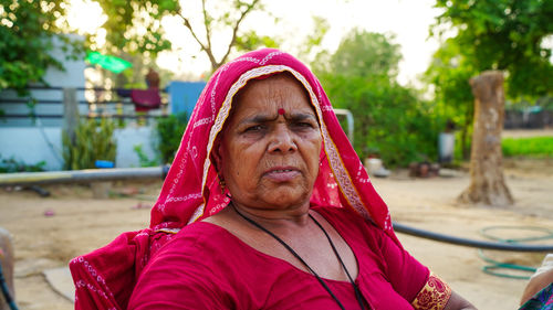 Portrait of woman with pink umbrella