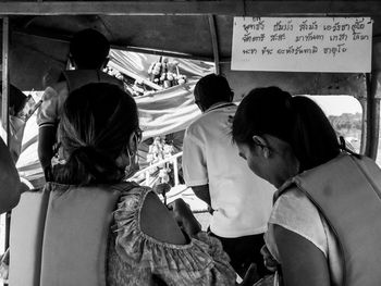 Rear view of people sitting in bus