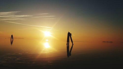 People jumping at sunset