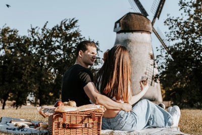 Young couple having a picnic in the park.