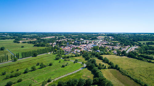 High angle view of agricultural field against clear blue sky