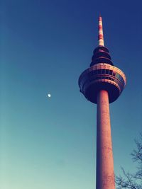 Low angle view of communications tower against clear sky