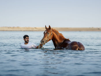 Man and horse in water
